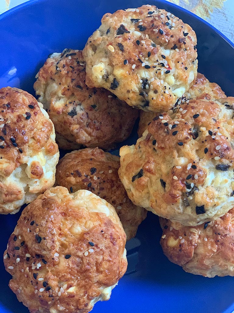 Close up image of Boikos rolls baked to a golden brown color topped with herbs